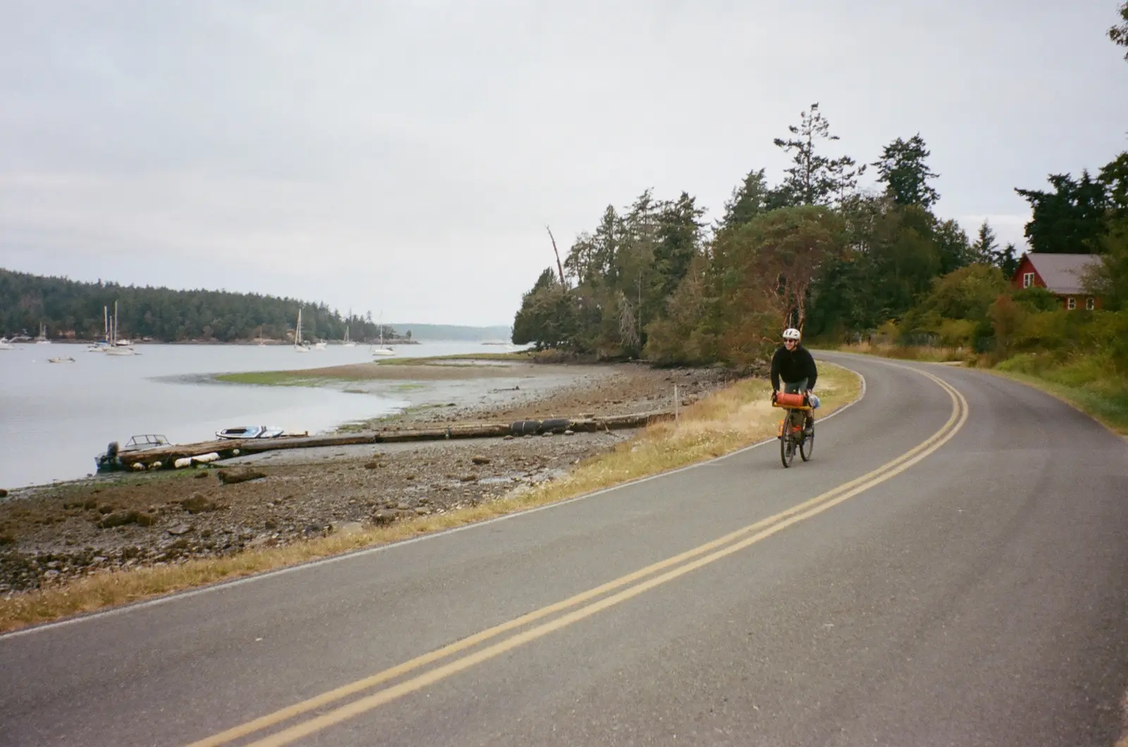 Bike traveler approaching on a quiet island road
