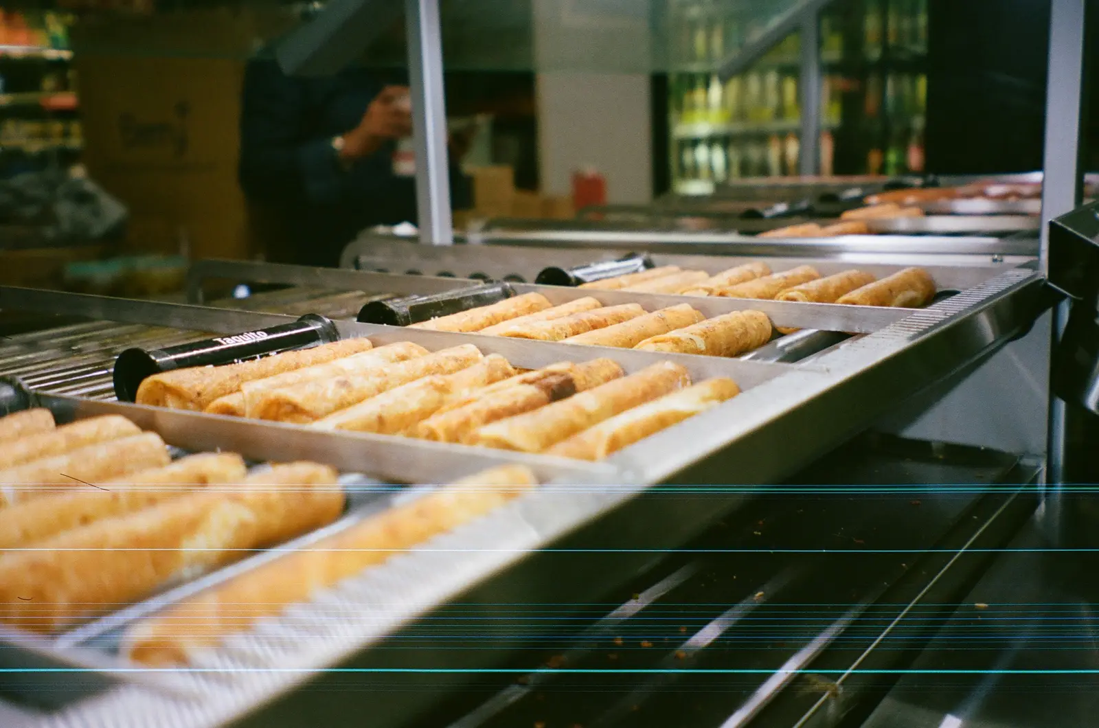 Rows of pastries behind a bakery counter