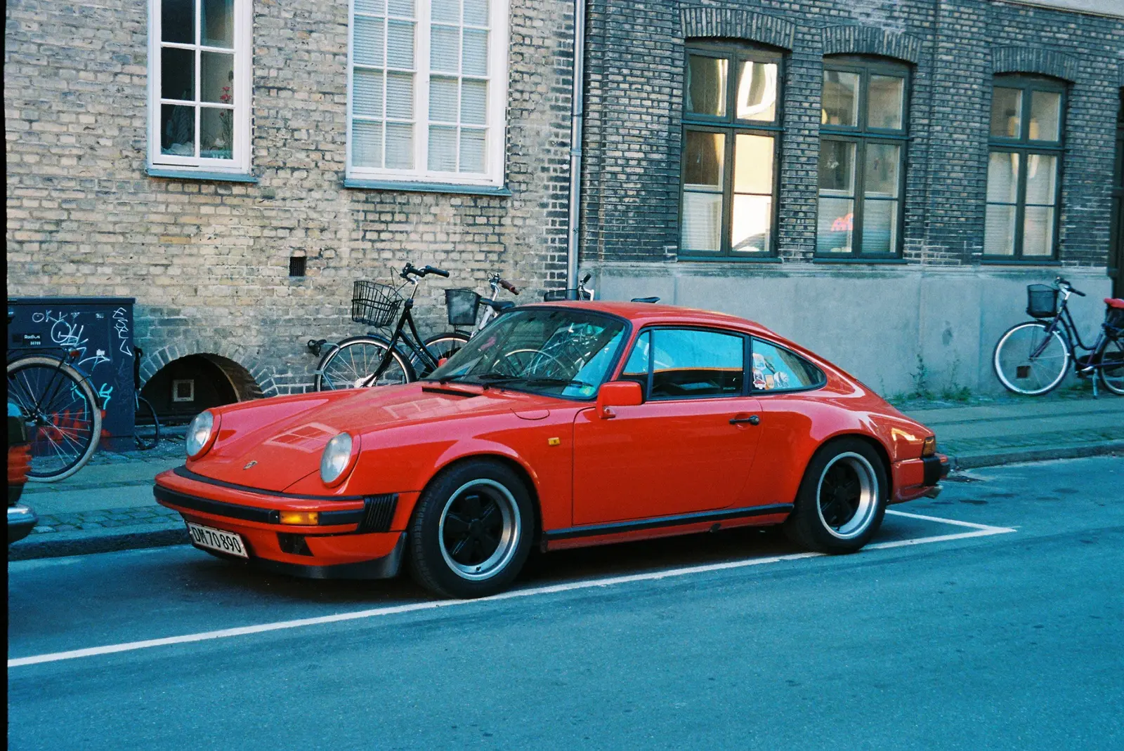Red Porsche parked on a Copenhagen street